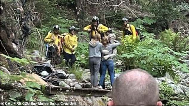 Lukas is hugged by his mother and sister after hearing cries for help