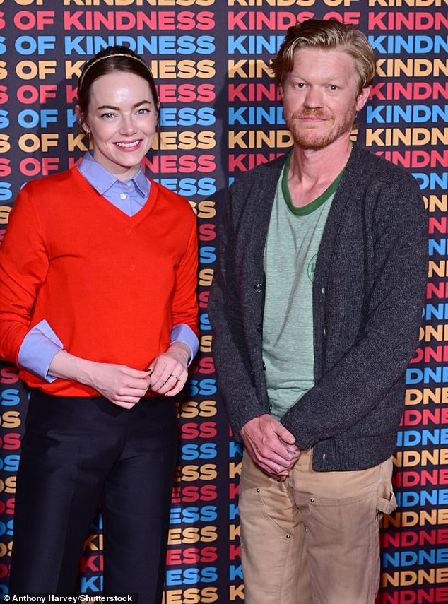 Emma looked chic in a tight blue shirt that she wore under a striking red V-neck sweater