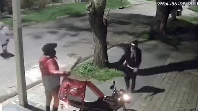 The man is seen taking a machete from his insulated bag when he encounters the would-be robbers, who respond by running away