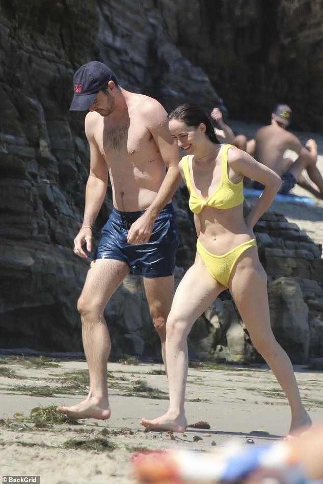 The actress flashed a huge grin as she walked through the sand with her boyfriend