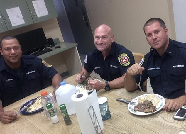 Shawn, far right, is pictured eating at the firehouse with fellow firefighters, Jed Cash, left, and Jason Morrison, center