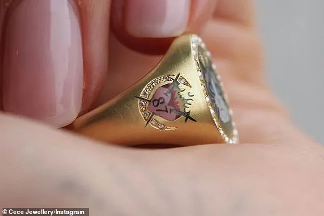 The gold ring features Travis' Jersey number '87' in a flaming love heart on one side of the band, in a seemingly telling sign