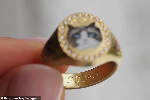 The gold ring also features an image of Taylor's famous cat Benjamin Button, as well as an engraving of the initials from her new album, The Tortured Poets Department.