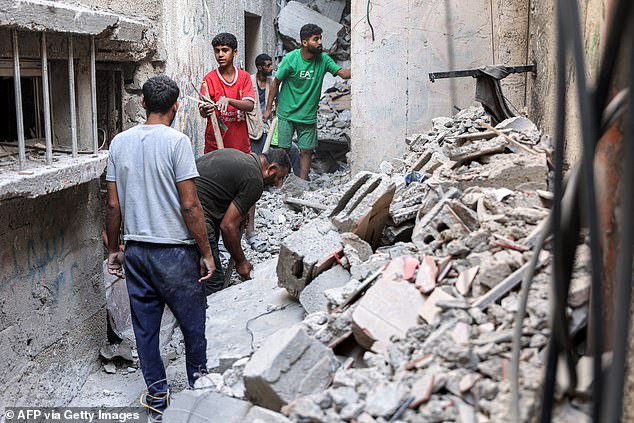 Men search the rubble of the house, with rescuers saying they do not have the equipment to retrieve all the victims