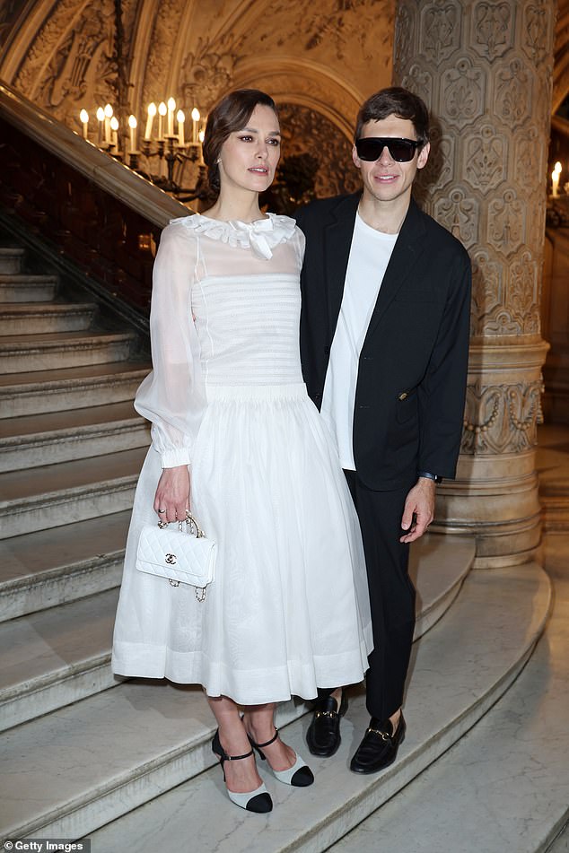 Keira's husband also added a few dark shades to his ensemble, despite posing indoors