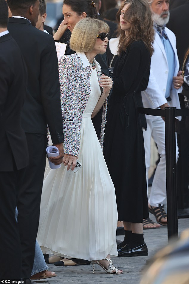 Anna Wintour was also spotted arriving wearing a beautiful cream pleated dress with a colorful blazer jacket