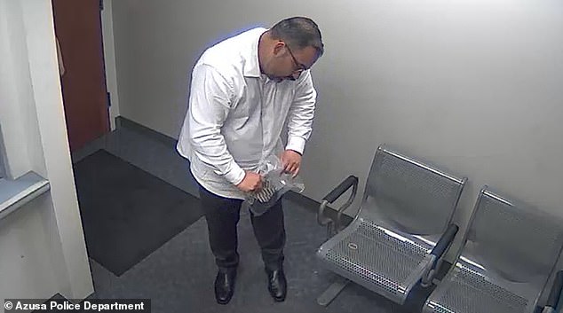 A still image from jail surveillance video shows Los Angeles Chief Deputy District Attorney Joseph Iniguez calling from jail following a 2021 arrest for public intoxication