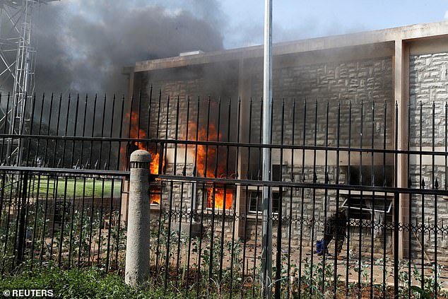 Flames rise from a parliament building on the day of a demonstration against Kenya's proposed finance law in Nairobi, Kenya, June 25