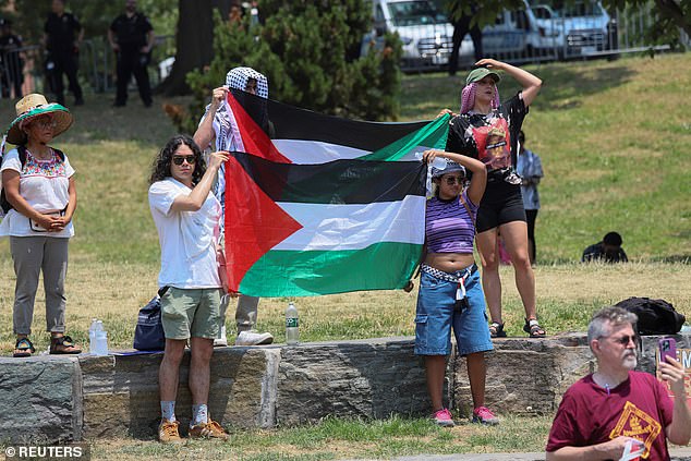 Supporters hold Palestinian flags during Jamaal Bowman's campaign rally