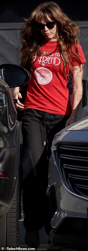 For her latest sighting, Miley cut a casual figure in a cherry red T-shirt and black jeans, fending off the California rays with sunglasses