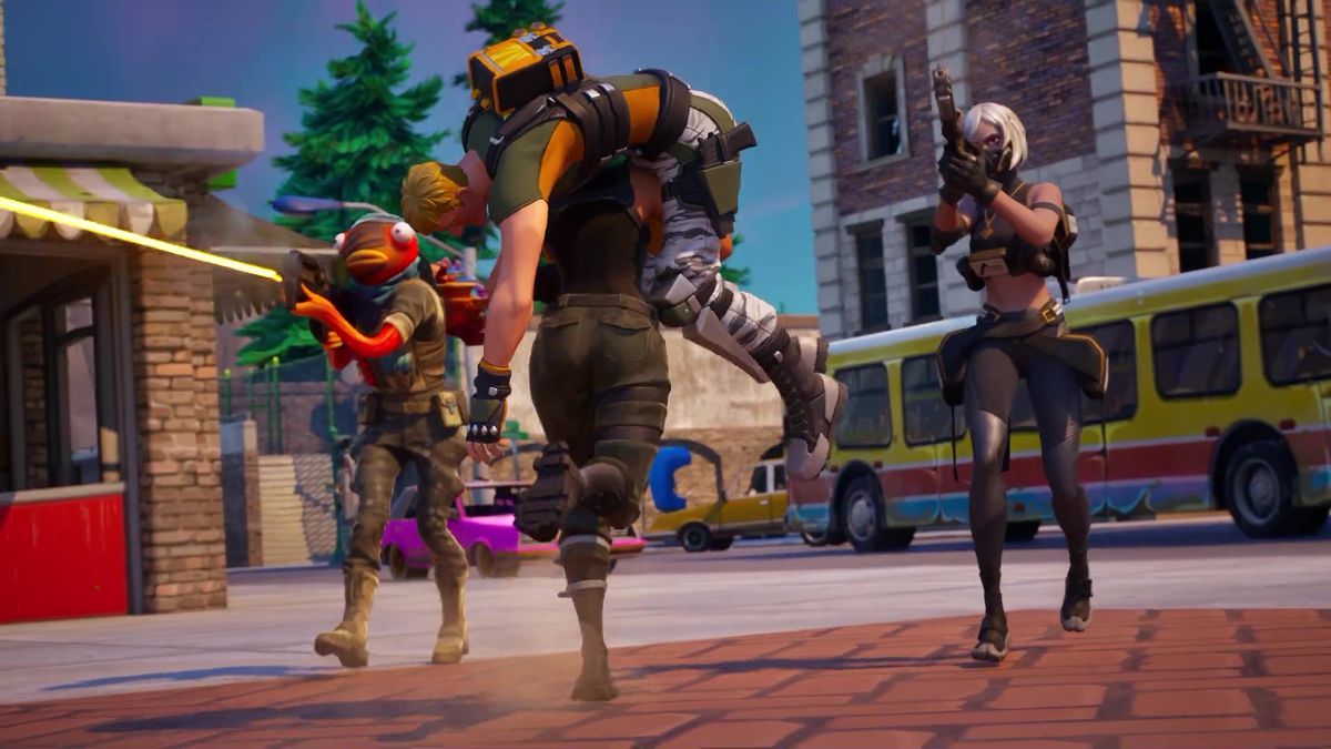 A still from a trailer for Fortnite Reload.  It shows two players covering another two players while one runs and carries the other on his shoulders.