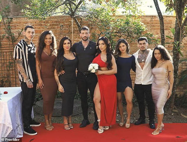 OnlyFans adult content creators Máximo García (fourth from left) and his wife, Luiza Marcato, (fourth from right) with their groomsmen and bridesmaids