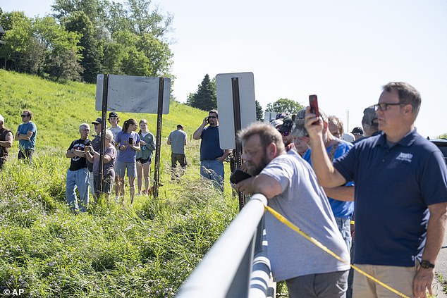 Onlookers get a glimpse of the damage to the Rapidan Dam in Rapidan on Monday