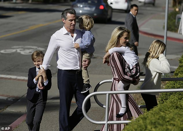 California gubernatorial candidate Gavin Newsom walks with his family to vote on Tuesday, November 6, 2018 in Larkspur, California