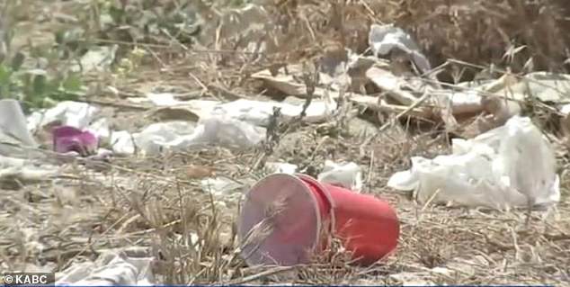 Video shows empty beer bottles, plastic cups, cardboard boxes and graffiti covering the once pristine hillside