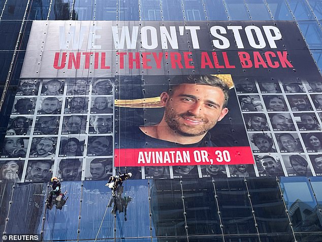 Avinatan Or's face is seen on a tower with the faces of hostages in Israel on May 26