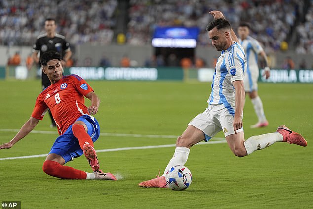 Chilean Dario Osorio tries to block a shot from Argentinian Nicolas Tagliafico