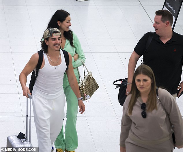 Anna made a style statement in a green tracksuit from Juicy Couture as she walked through the terminal with Aymeric