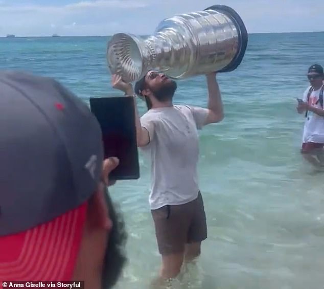 After taking a dip in the ocean, Tkachuk, 26, kissed the cup while holding it above his head