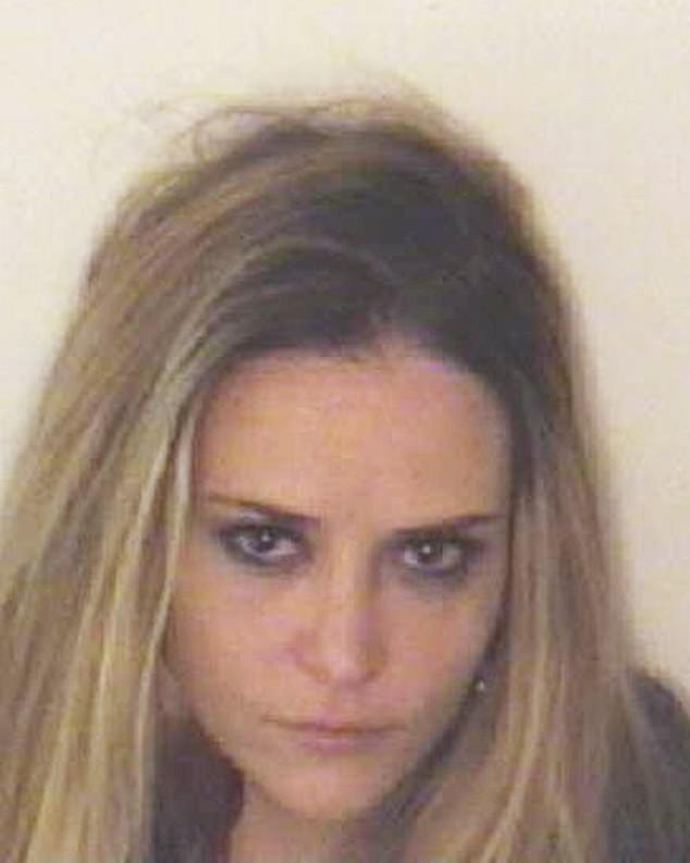 Brooke Mueller poses for her mugshot after being arrested and charged with assault and possession of cocaine with intent to distribute on December 3, 2011