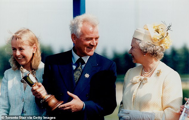 Stronach (pictured with the late queen) did
