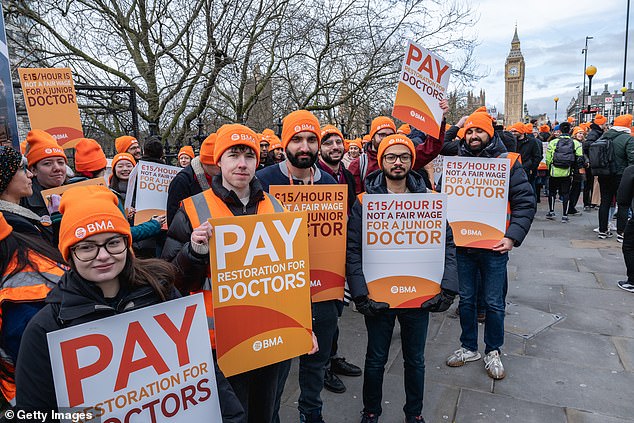 The orange hats have become synonymous with the BMA picket lines during previous industrial action.  Medics pictured striking outside St Thomas' Hospital in Westminster on February 26 earlier this year