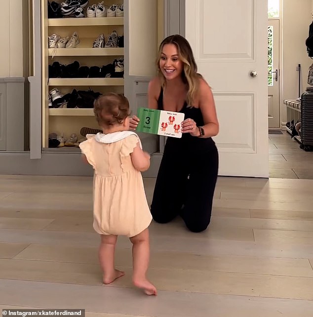 The doting mother and wife of Rio Ferdinand, 33, couldn't stop gushing over the toddler as she held up a book - but Rio wasn't too happy with something he saw in the video