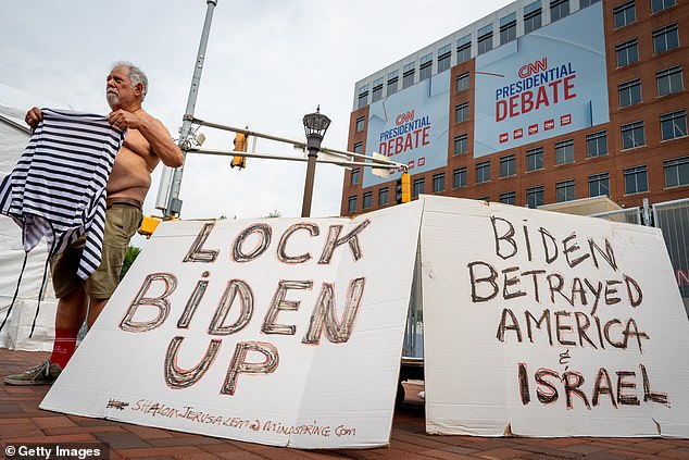 A shirtless anti-Biden protester appeared early outside the debate venue with signs criticizing the president for his policies against Israel