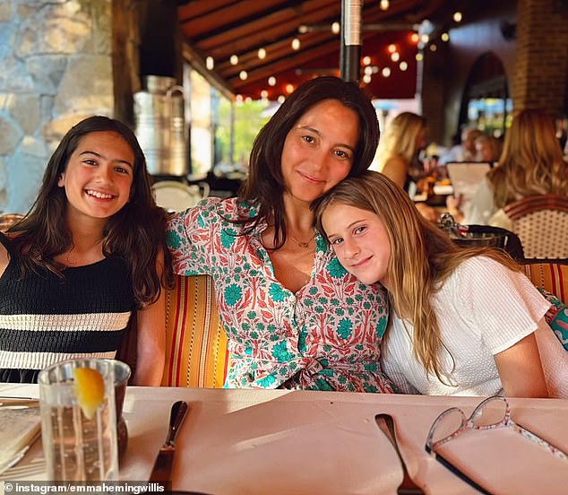 Emma is pictured with the couple's daughters, Mabel, 12, and Evelyn, nine