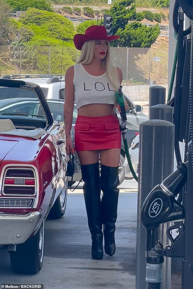 Kesha completed her summer ensemble with a red cowboy hat, red skirt and black thigh-high boots at the gas station