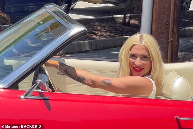 She drove the convertible off the lot before driving back into the station, where the manager blocked her way, according to TMZ