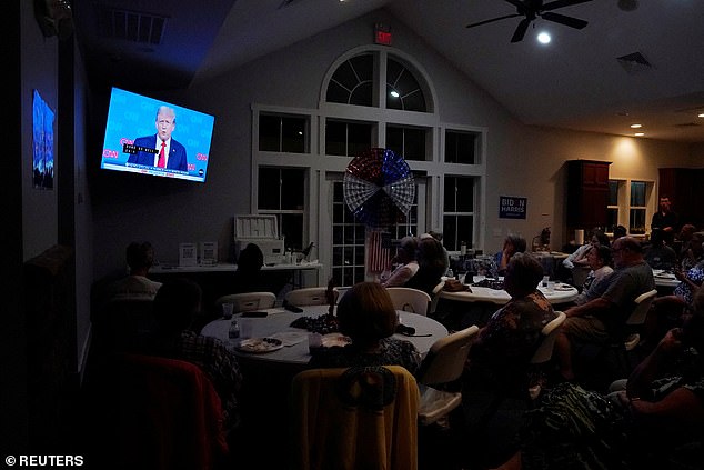 A TV screen shows the debate as the New Hanover County Democratic Party hosts a viewing party as former US President Donald Trump faces off against US President Joe Biden