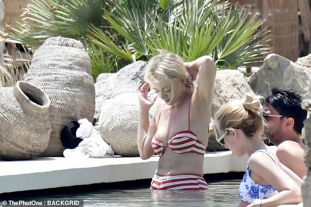 Jackie wore a chic red and white striped bikini with a balconette bra and tiny shorts that showed off her slim figure