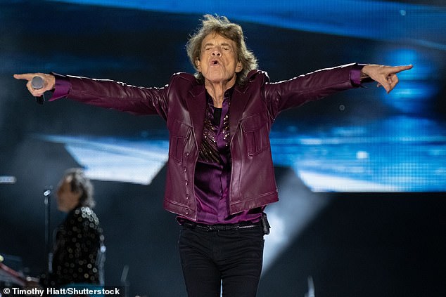 For the incredible night, Mick wore a maroon leather jacket with a shiny matching top underneath