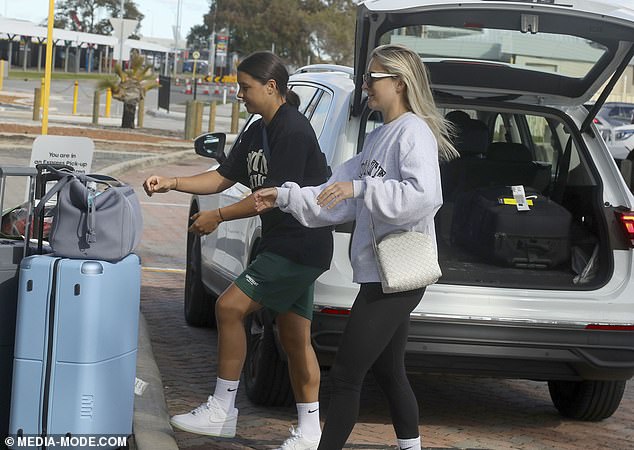 The couple appeared to be in good spirits as they loaded their suitcases into the back of an SUV