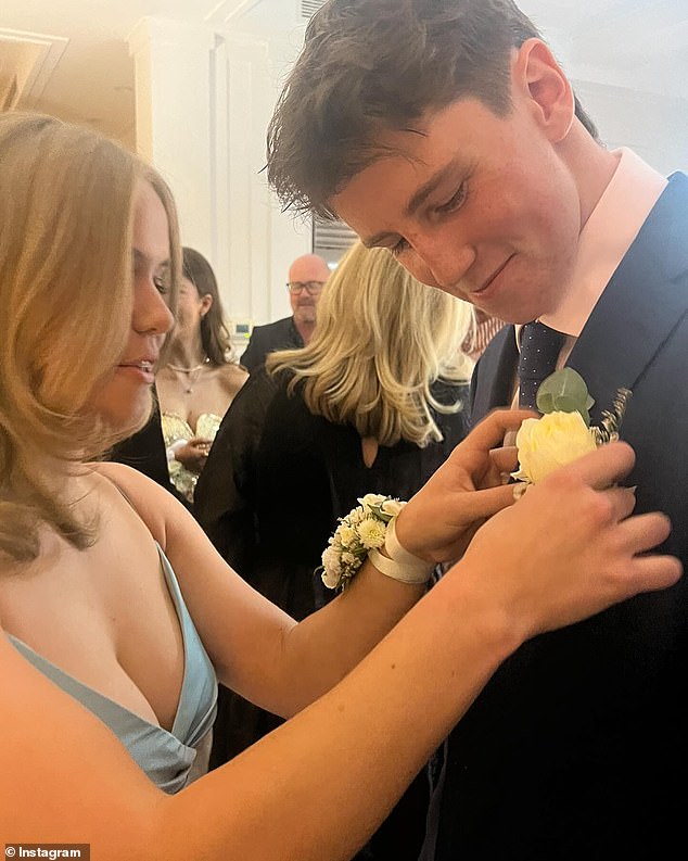 Wearing a blue satin dress, Daisy was photographed tying a corsage to River's lapel as they got dressed for the exciting night