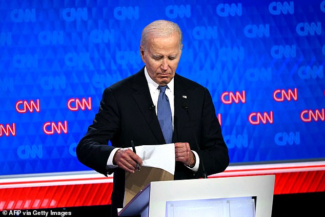 At times, President Biden looked blankly into the camera or at his notes (photo) while Trump was speaking