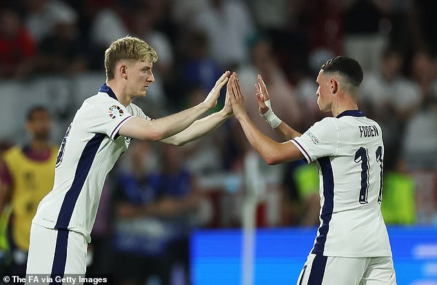 Gordon made his European Championship debut as a substitute against Slovenia when he replaced Phil Foden (right)