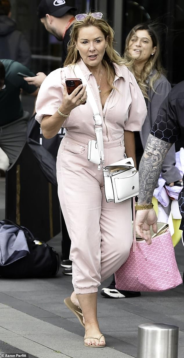 The When You Believe singer kept it casual as she paired a baby pink denim jumpsuit with slides