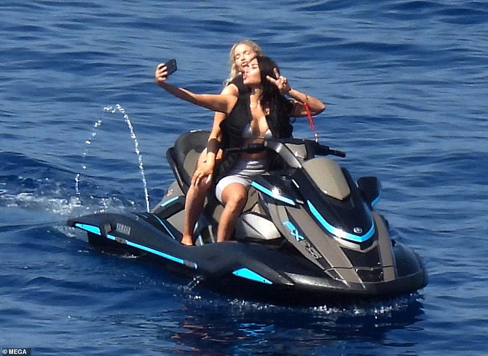 Kim Kardashian, who was on a separate jet ski with a blonde friend, also looked at ease on the water
