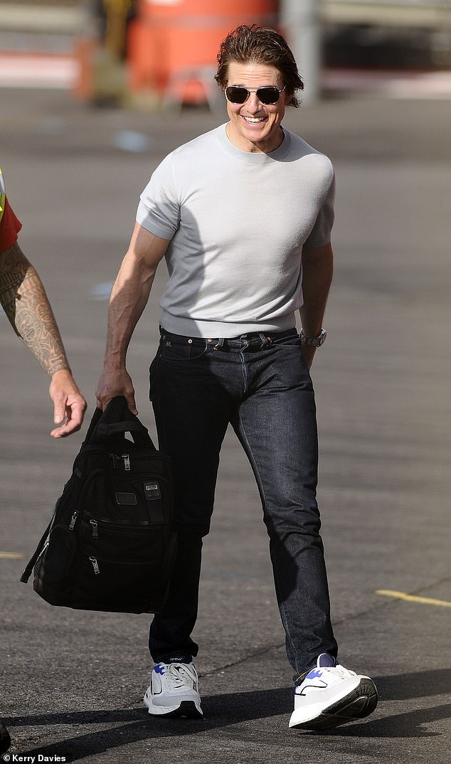 The American actor and film producer, 61, looked handsome as he showed off his muscular arms in a gray slim-fit T-shirt