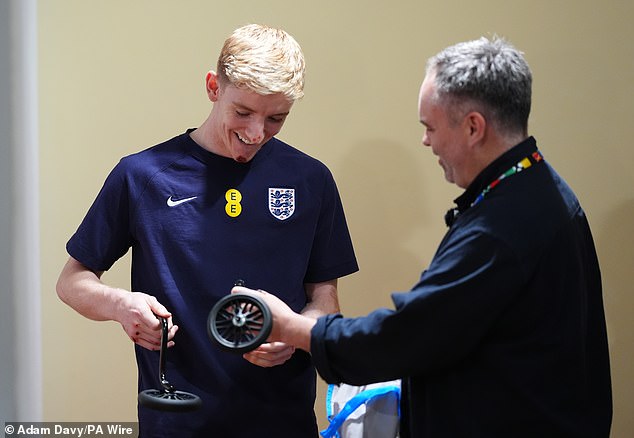 The gift, which the England winger promises to use as part of his celebrations if he scores against Slovakia on Sunday, came from Mail Sport photographer Kevin Quigley (right)
