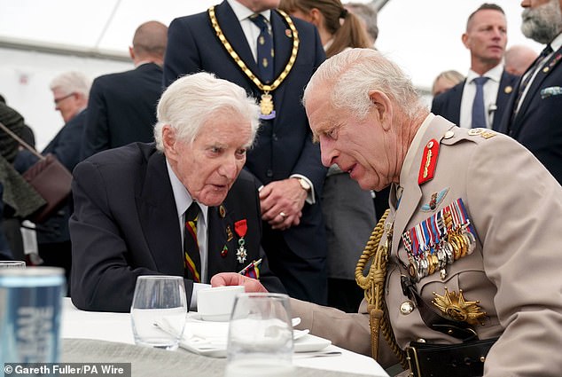 King Charles III speaks with D-Day veteran Peter Newton, 99, at a lunch after Britain's national commemoration event for the 80th anniversary of D-Day in Normandy on June 6