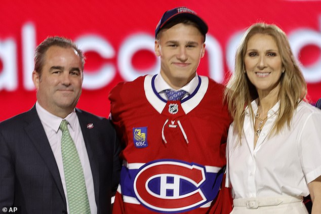 Ivan Demidov, center, poses after being selected by the Montreal Canadiens in the first round of the NHL hockey draft