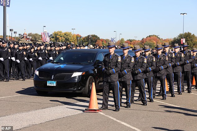 Thousands of police officers from across the country gathered at a football stadium in Connecticut on Friday for a funeral for two officers shot dead in an ambush.