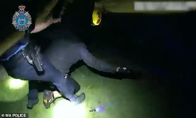 After a second officer arrived, the two pushed the suspect (photo) to the ground