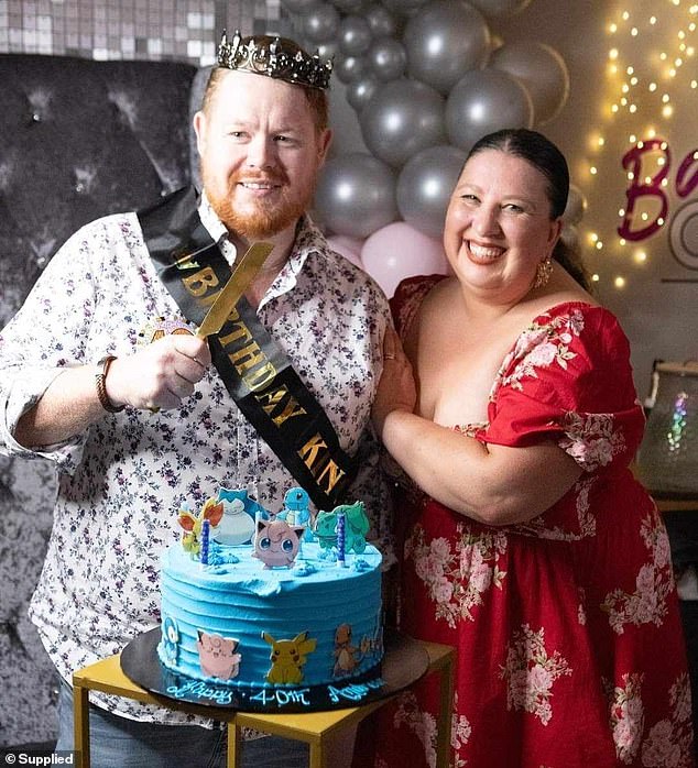 Mr Trigg has just turned 40 and has set himself the goal of pushing himself to see his wife perform in a musical at the end of July (pictured with his wife Kylie on his 40th birthday)