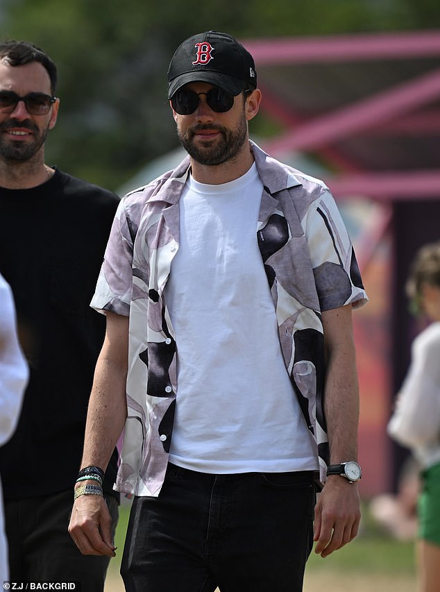 Jack Whitehall, 35, looked casual in a white T-shirt and a bright shirt as he wandered through the fields