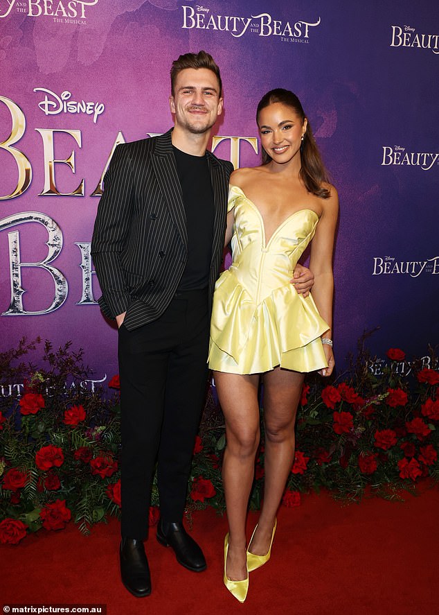 The former Miss Universe Australia carried her handsome boyfriend on her arm at the Beauty and the Beast premiere in Melbourne on Saturday. The beauty queen couldn't wipe the smile off her face as she snuggled up to the handsome mystery man