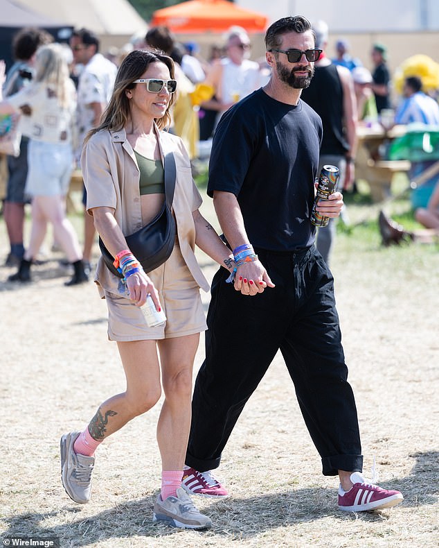 The 50-year-old Spice Girl looked cool in an open beige shirt and short co-ord set, while her pretty companion wore an all-black outfit